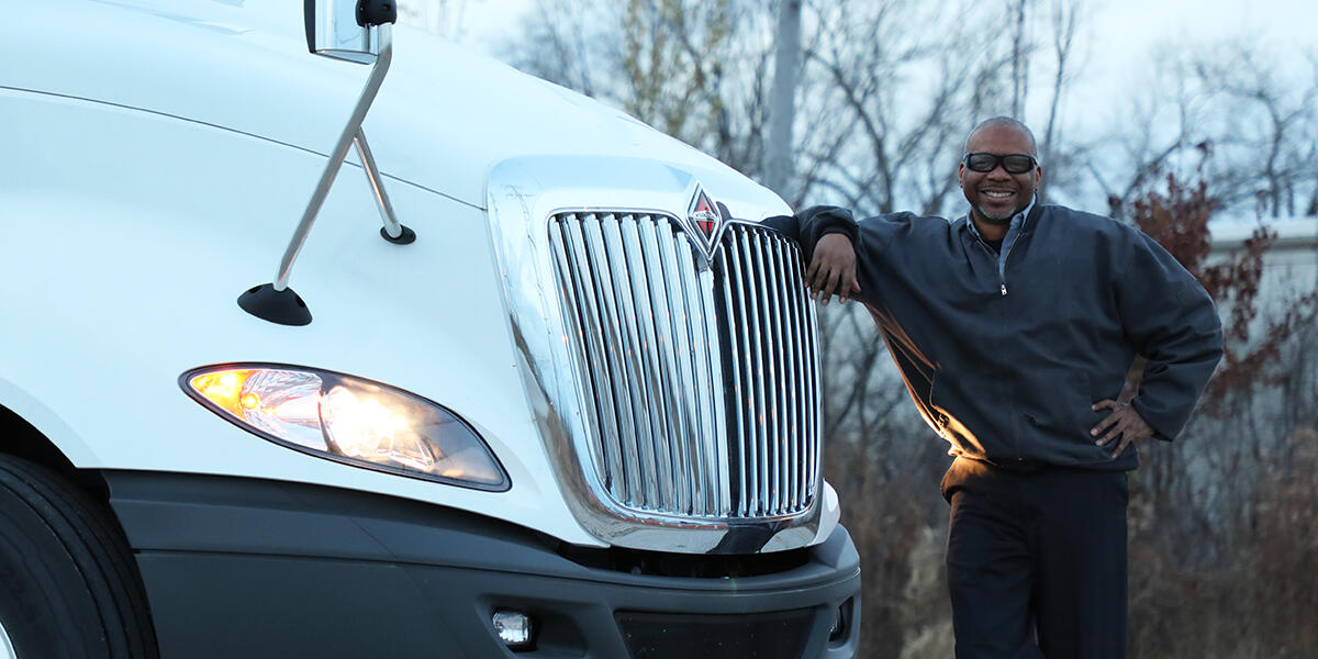 Driver standing next to his International LT