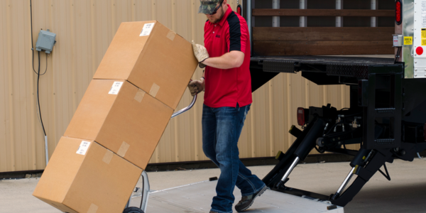 delivery driver stepping off liftgate