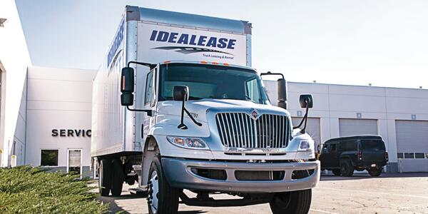 Box truck in front of dealership