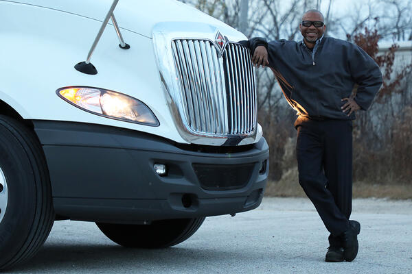 Driver standing next to his International LT